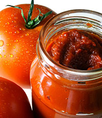 Tomatoes and jar of Tomato Paste