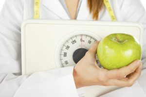 http://www.dreamstime.com/stock-photography-nutritionist-holding-green-apple-weight-scale-image28463742