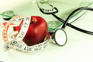 apple, tape measure, scale, stethoscope