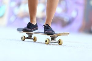 Teenager Skater Girl Legs On A Skate Board