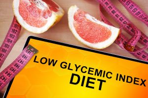 low glycemic index sign with grapefruit wedges and tape measure on table