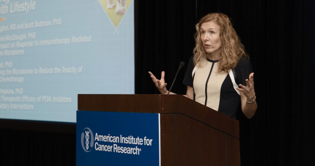 woman at podium during the 2019 cancer research conference
