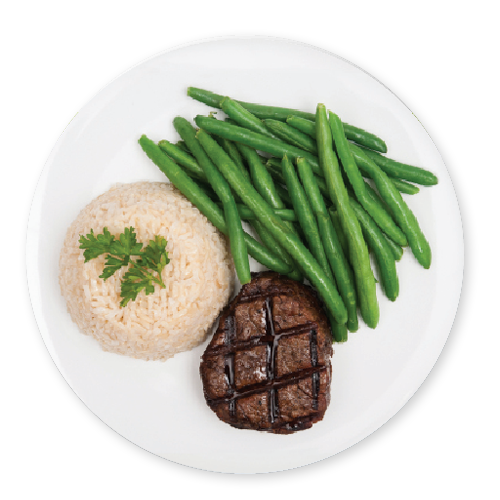 a dinner plate containing a small fillet steak, with a large helping of green beans and wholegrain brown rice.