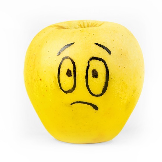 an apple with a stressed facial expression